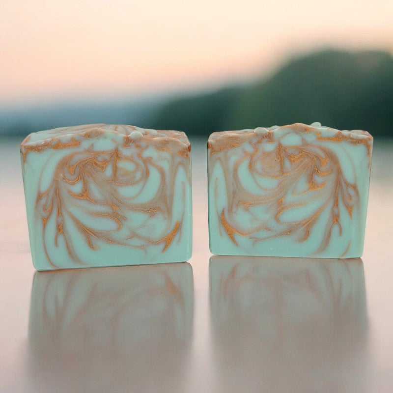 Two bluish-green and copper swirled soap bars scented with patchouli (dark) essential oil