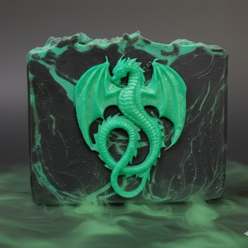 A black soap with green swirls with a green dragon on the front