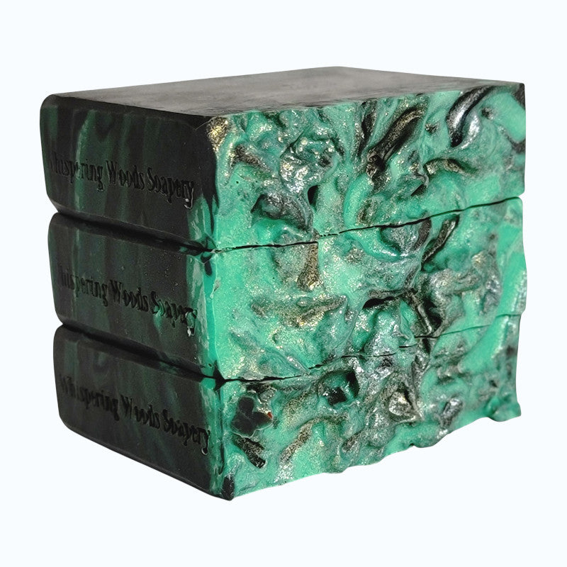Three bars of soap with a textured green and black design on a white background