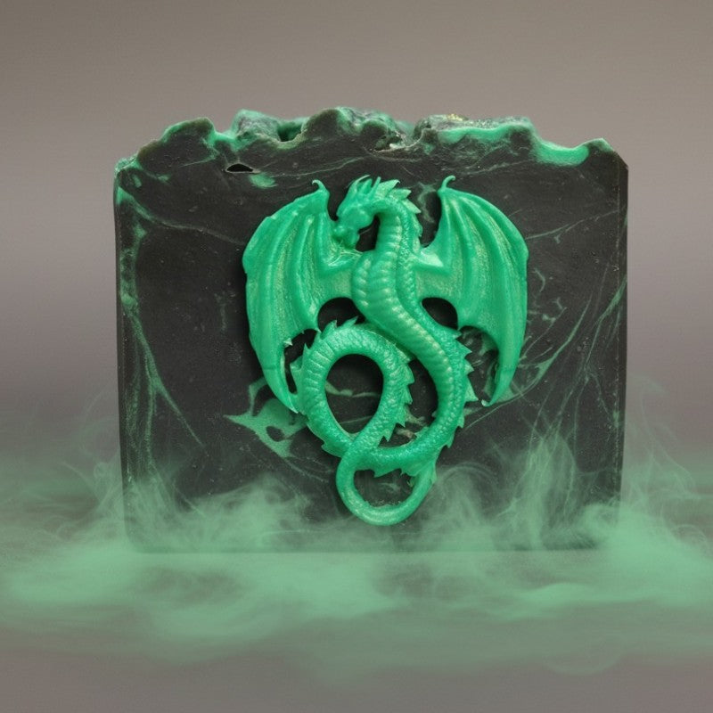 A black soap with green swirls with a green dragon on the front