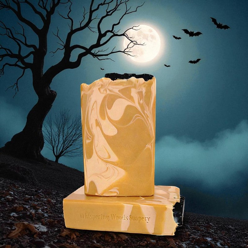 Marble-patterned orange soap with 'Whispering Woods' branding against a moonlit night sky with bats and trees