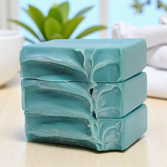 Stack of three blue soap bars with a blurred indoor background