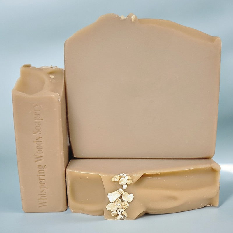 Three pale-brown soap bars on a dusky blue background