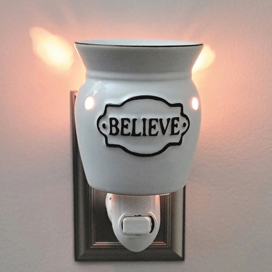 White wax burner with 'BELIEVE' text on a gray wall