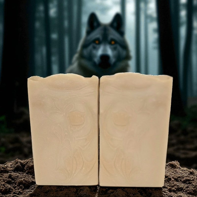 Two bars of soap with a mysterious woods and wolf in the background