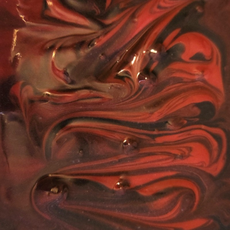 Close-up of freshly poured soap with blood red and black swirls