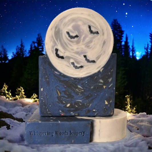 Dark blue speckled soap base with a full moon and bats sitting on it