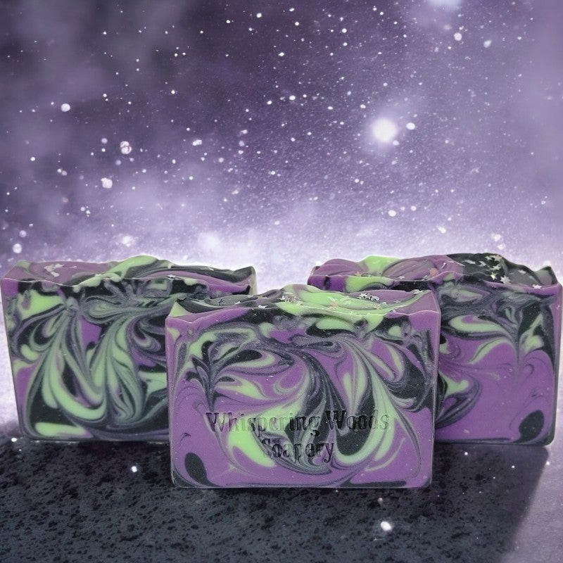 Three bars of soap with delightful purple, black and green swirls. The tops have glitter moons and stars.