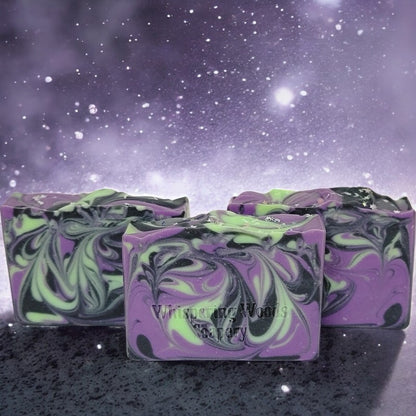 Three bars of soap with delightful purple, black and green swirls. The tops have glitter moons and stars.