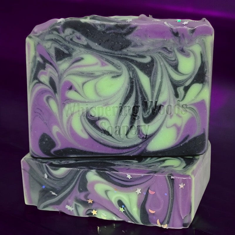 Two bars of soap with delightful purple, black and green swirls. The tops have glitter moons and stars.