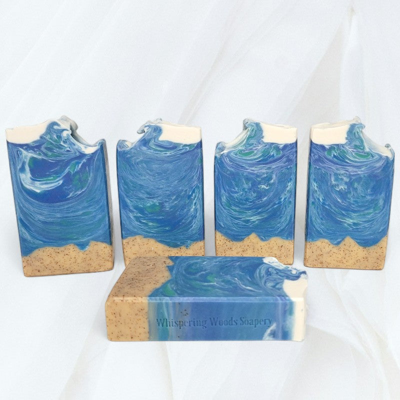 Five ocean-themed bars of soap on a white cloth background