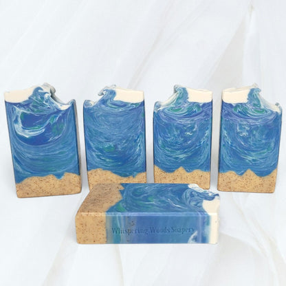 Five ocean-themed bars of soap on a white cloth background