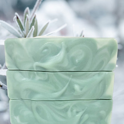 Close-up of the swirled creamy white and light green tops of soap