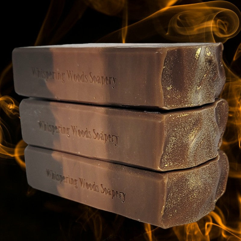 Three stacked bars of soap in shades of brown with gold sparkles on top