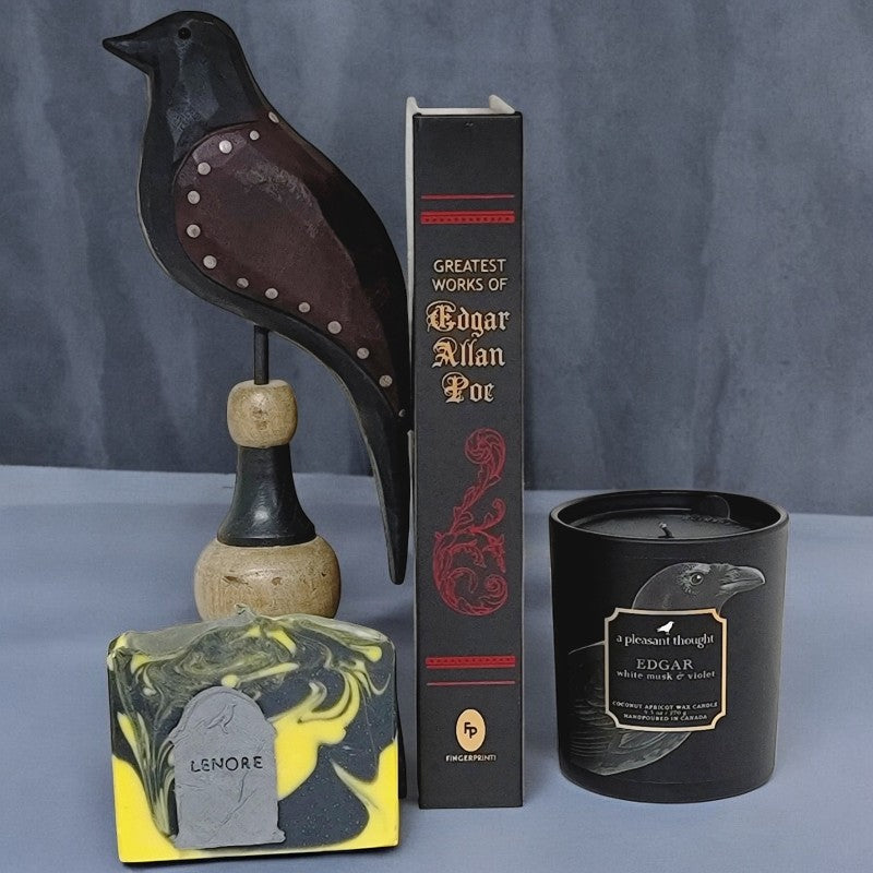 Poe Collection Lenore soap with an Edgar Allan Poe book and wooden raven figurine. The Edgar candle was purchased in Salem MA and was handmade by 'a pleasant thought' company.