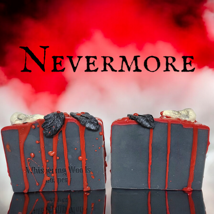 Black bars of soap with blood red drips, with a raven skull and feathers on top, sit on a reflective surface with red and white smoke behind them. The word NEVERMORE is above the soap.