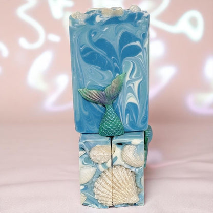 Three bars of soap with swirls of blue and white on a pearly shimmery background.