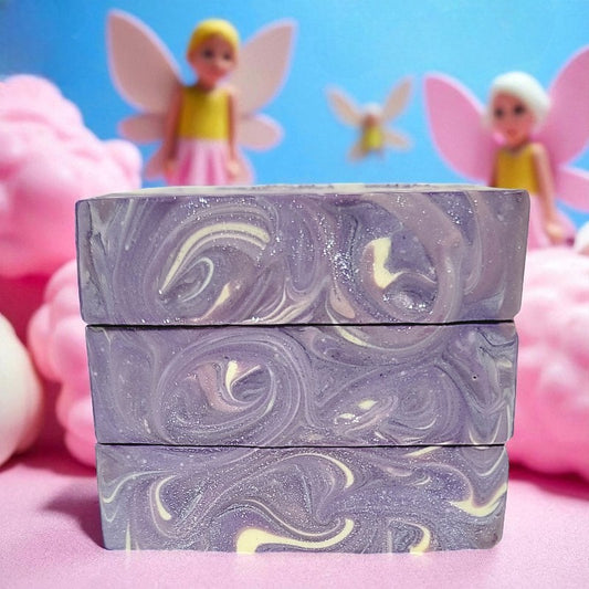 Stack of marbled soap bars with sweet sprites and cotton candy in the background