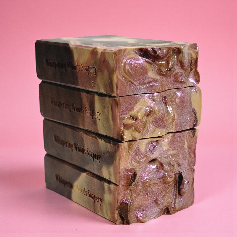 Stack of soap bars with marbled design on a pink background