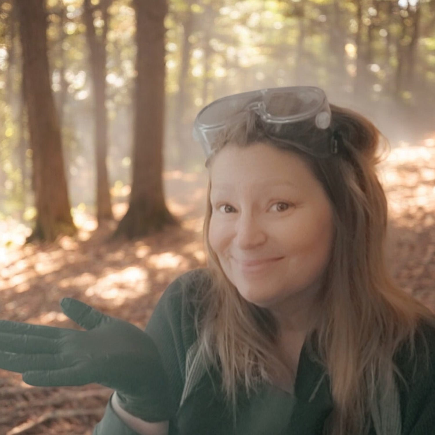 Whispering Woods Soapery Owner standing in soaping gear in sunlit woods