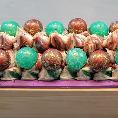Close-up of freshly piped white, red and green soap with red and green soap berries and lots of glitter